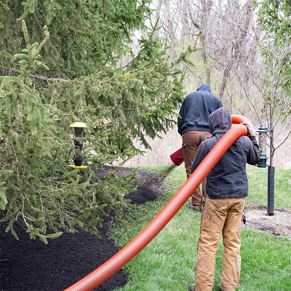 mulch blowing involves using a machine to evenly distribute mulch over a designated area